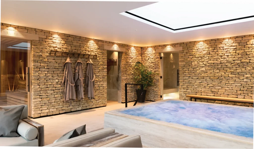 Hydrotherapy pool within thermal spa at Homefield Grange, showing natural stone materials and spa guest journey layout