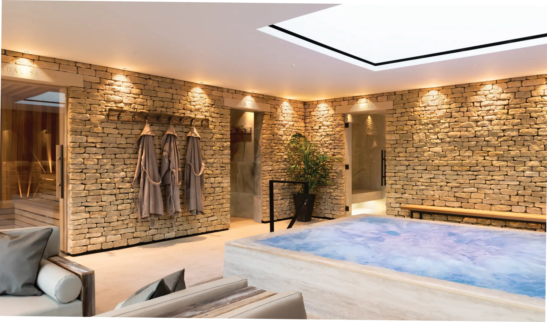 Hydrotherapy pool within thermal spa at Homefield Grange, showing natural stone materials and spa guest journey layout